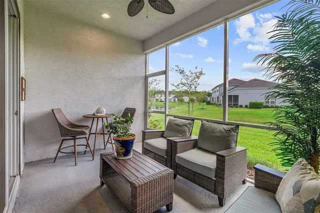 an aerial view of a residential houses with outdoor space and lake view