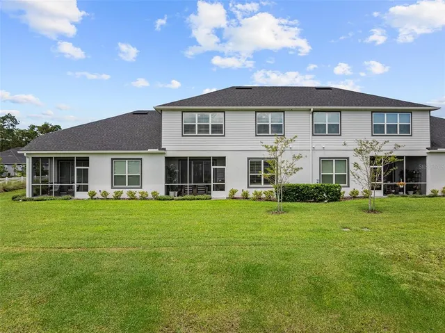 an aerial view of a swimming pool patio and outdoor seating