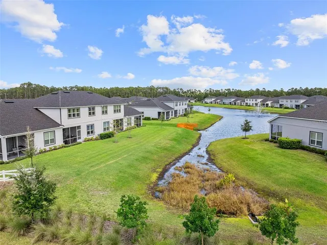 an aerial view of residential houses with outdoor space and swimming pool