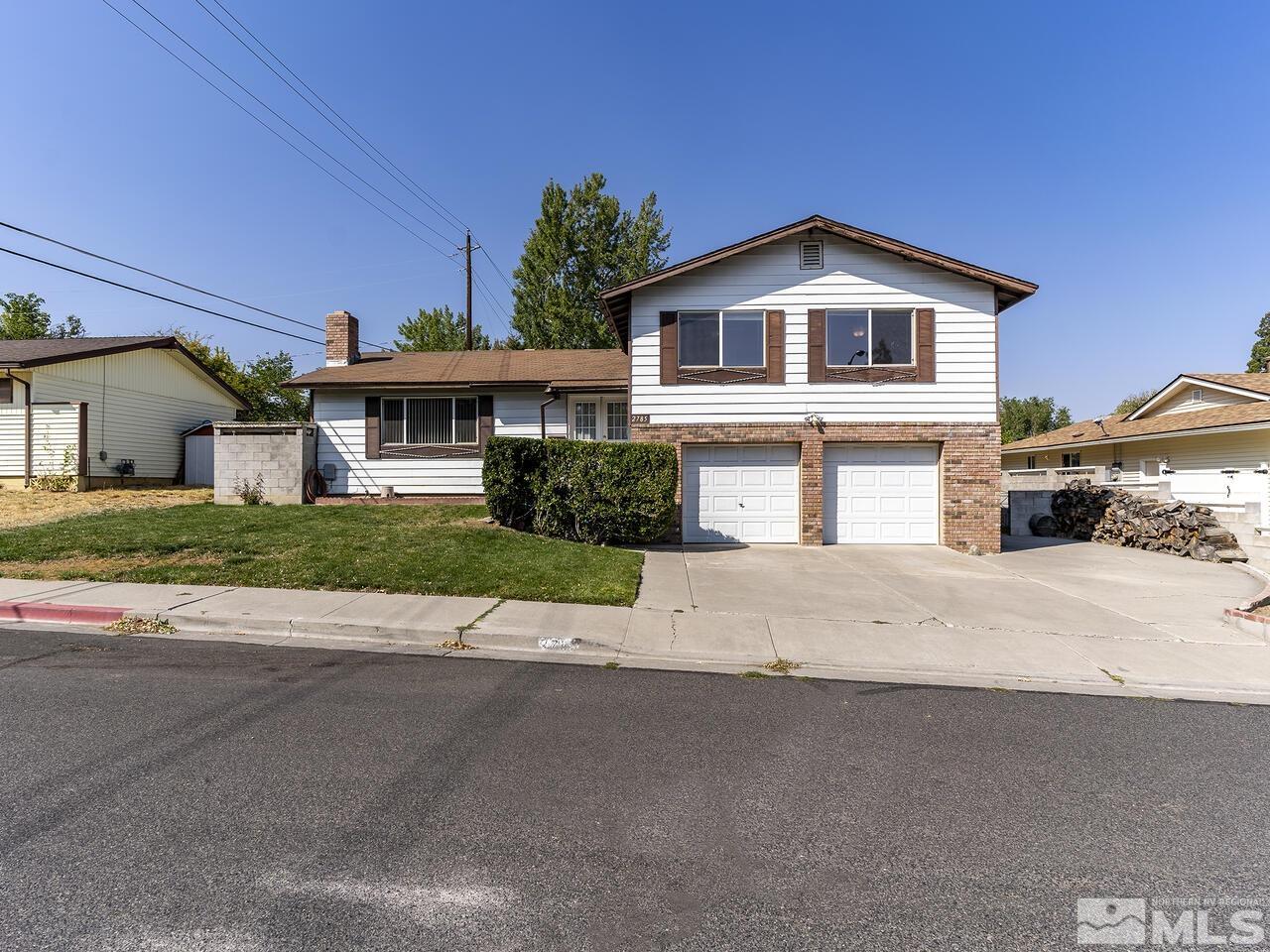 2785 Edgewood Drive Reno, NV 89503 - Photo 1 of 26 a front view of a house with a yard and garage