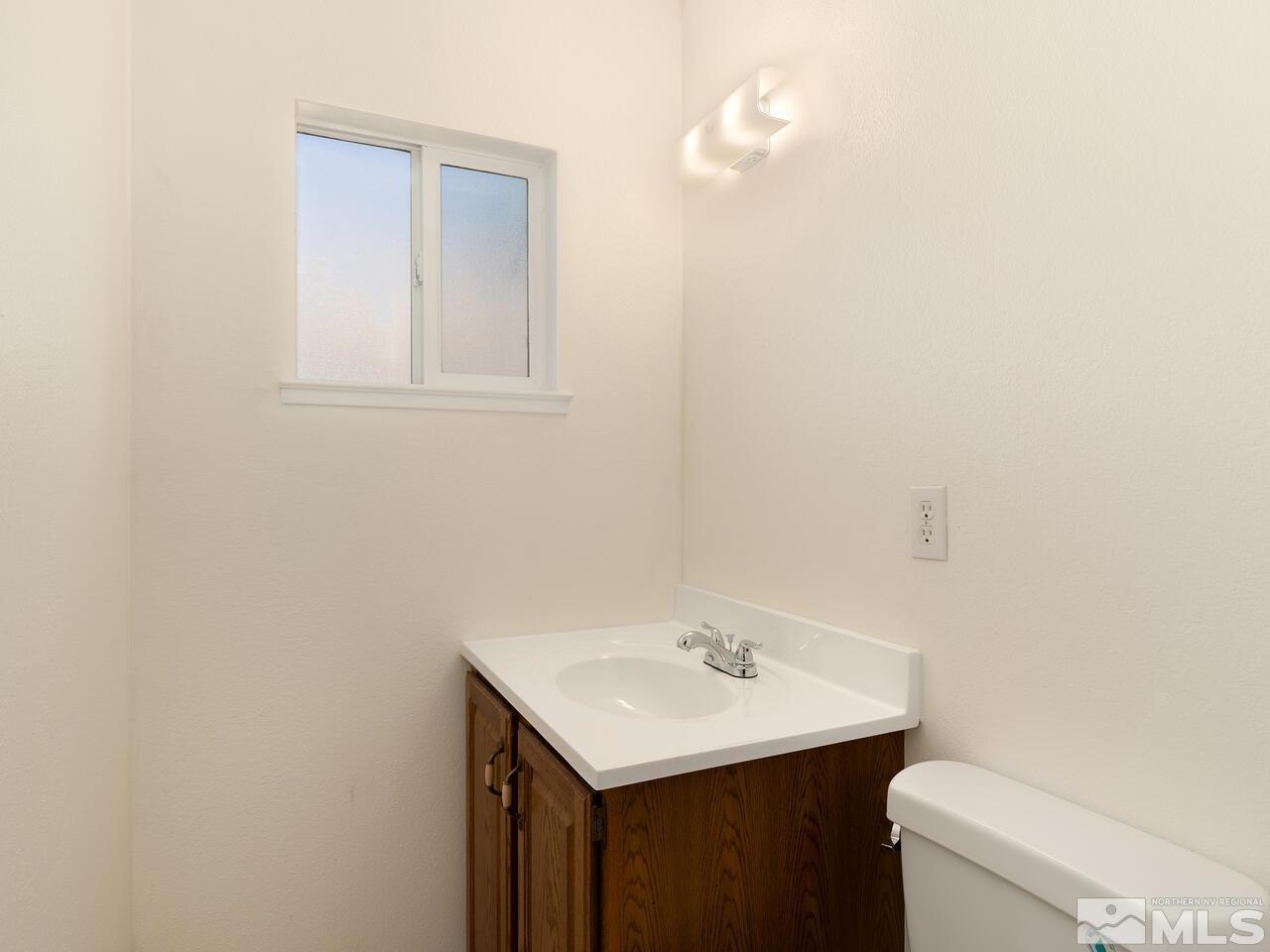 2785 Edgewood Drive Reno, NV 89503 - Photo 14 of 26 a bathroom with a sink vanity and a toilet