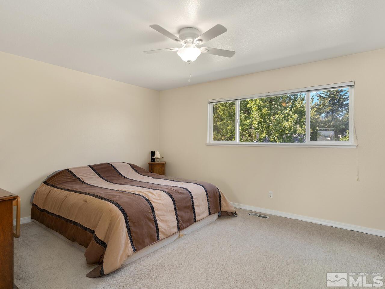 2785 Edgewood Drive Reno, NV 89503 - Photo 16 of 26 a bedroom with a bed and a large window