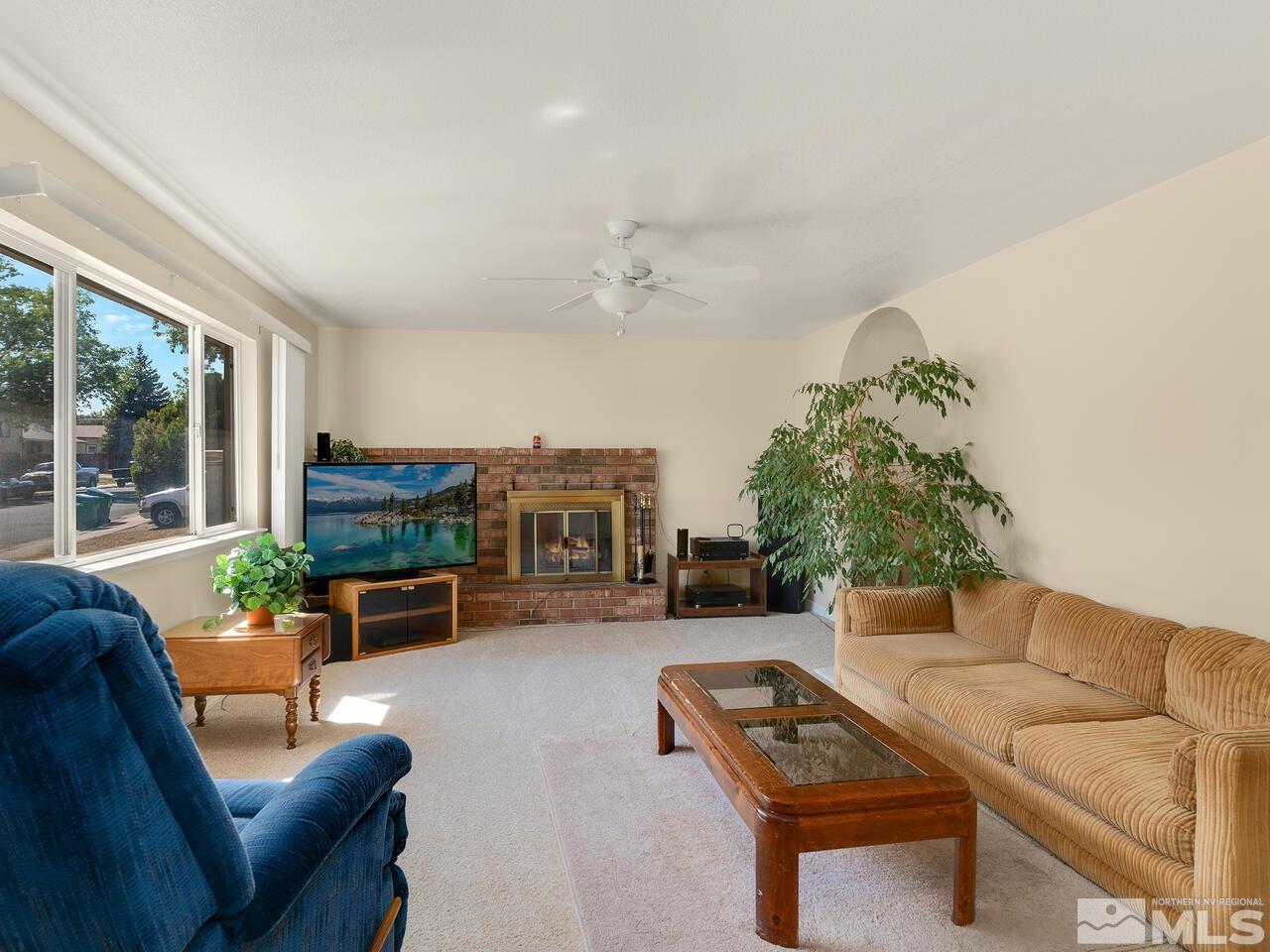 2785 Edgewood Drive Reno, NV 89503 - Photo 3 of 26 a living room with furniture a fireplace and a flat screen tv