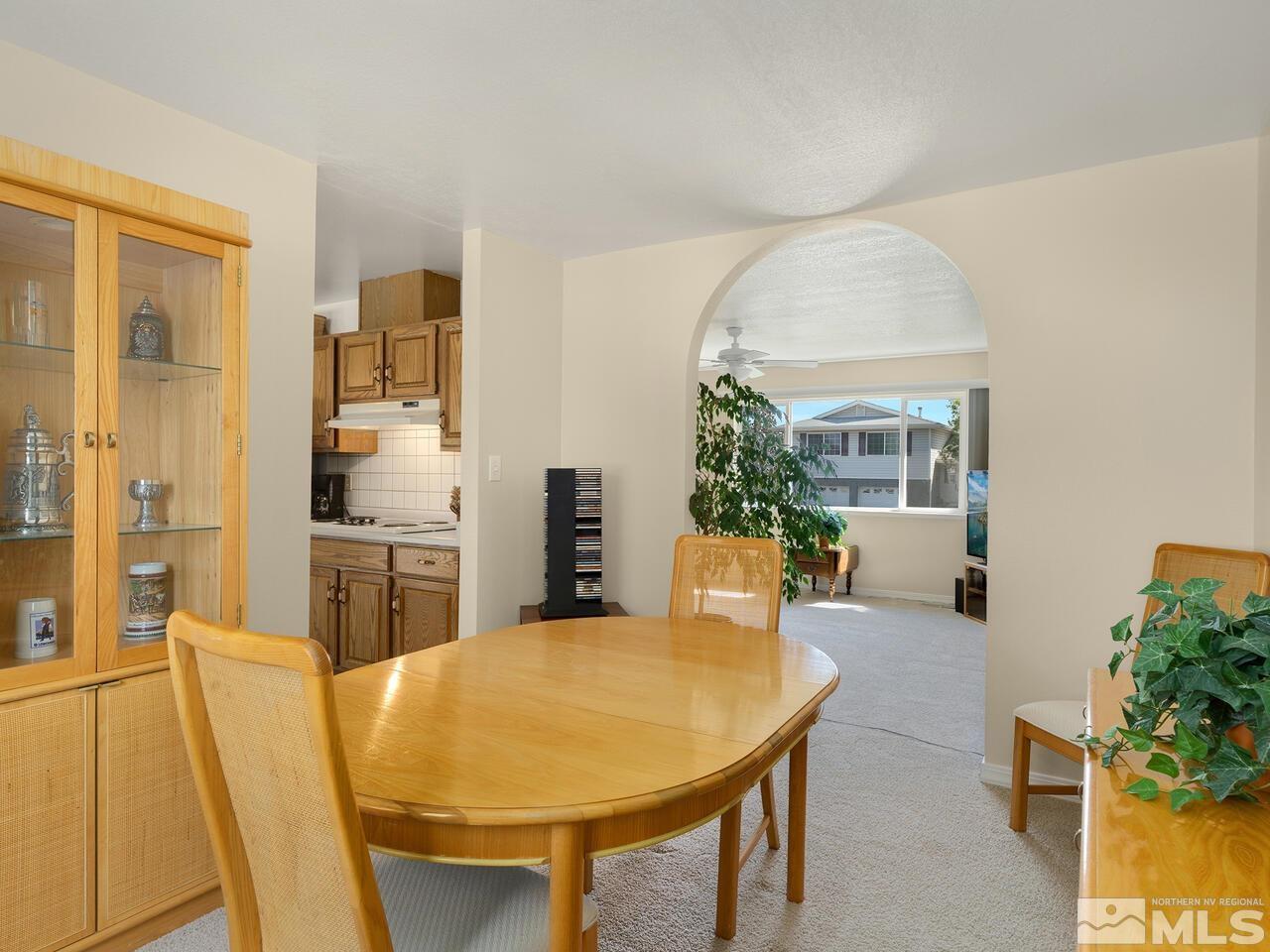 2785 Edgewood Drive Reno, NV 89503 - Photo 8 of 26 a living room with stainless steel appliances furniture a chandelier and a dining table
