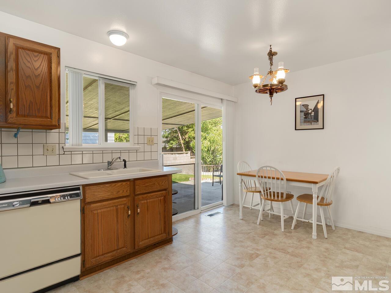 2785 Edgewood Drive Reno, NV 89503 - Photo 9 of 26 a view of a dining room with furniture a chandelier and window
