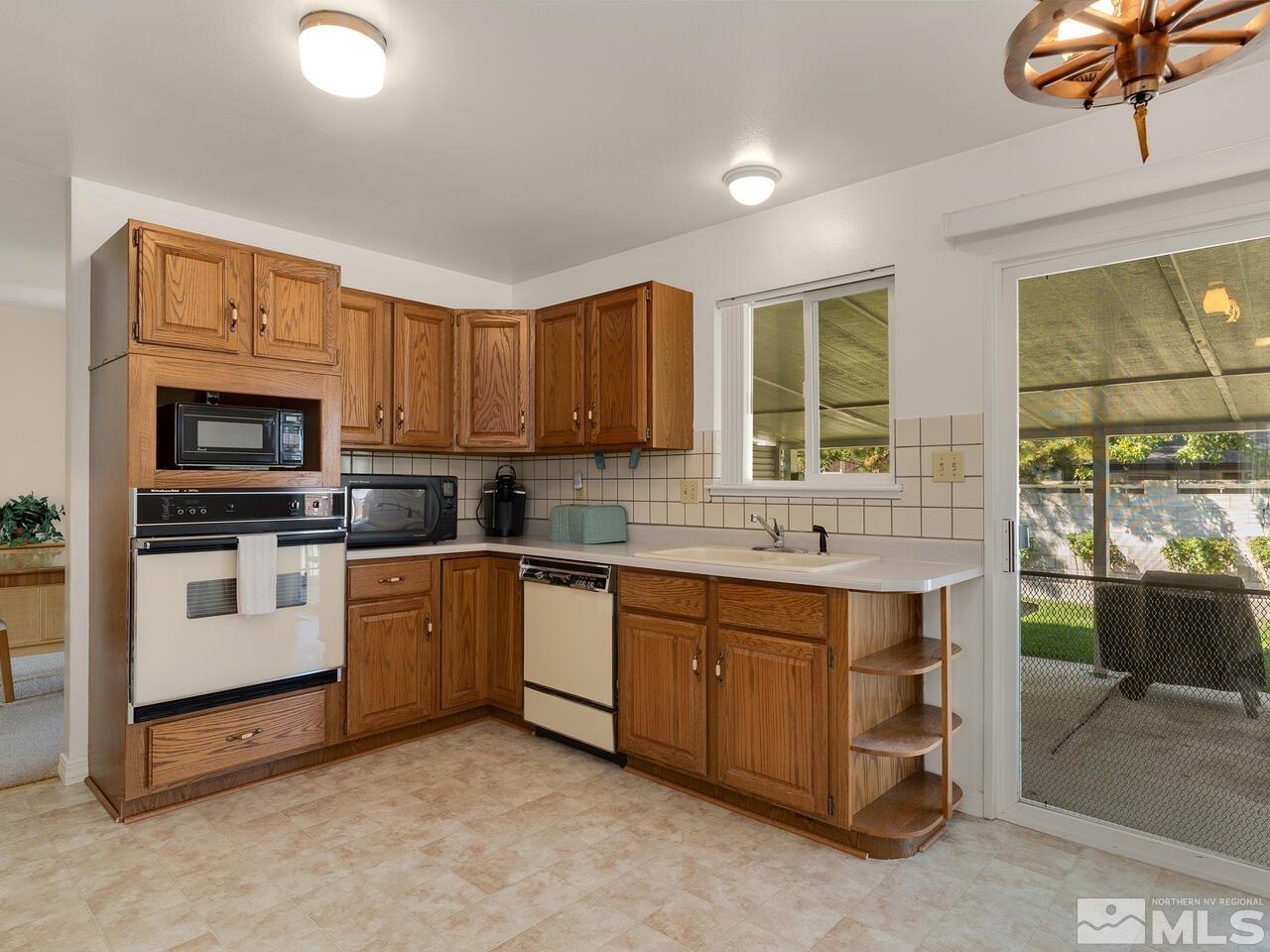 2785 Edgewood Drive Reno, NV 89503 - Photo 10 of 26 a kitchen with a sink stove and microwave