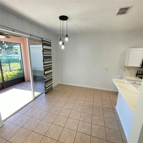 a large white kitchen with a cabinetry and stainless steel appliances