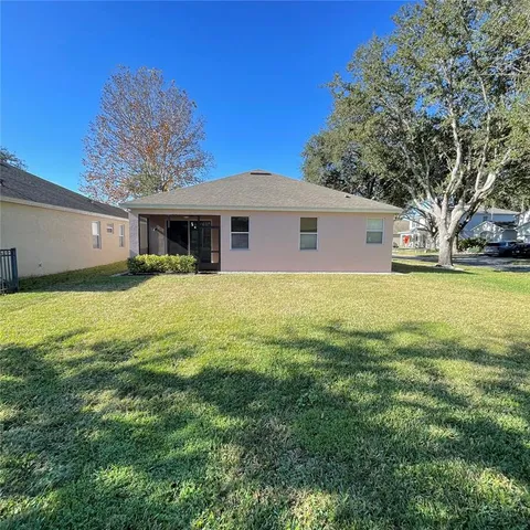 a front view of house with yard and trees around