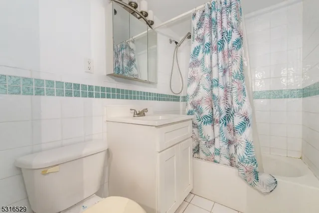 a bathroom with a sink a toilet and shower curtain