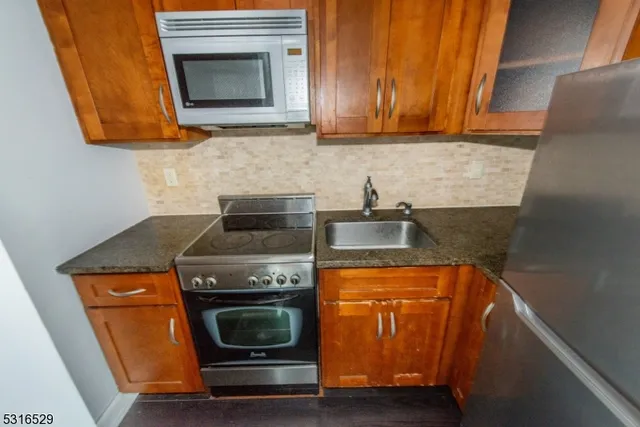 a kitchen with wooden floor and steel stainless steel appliances