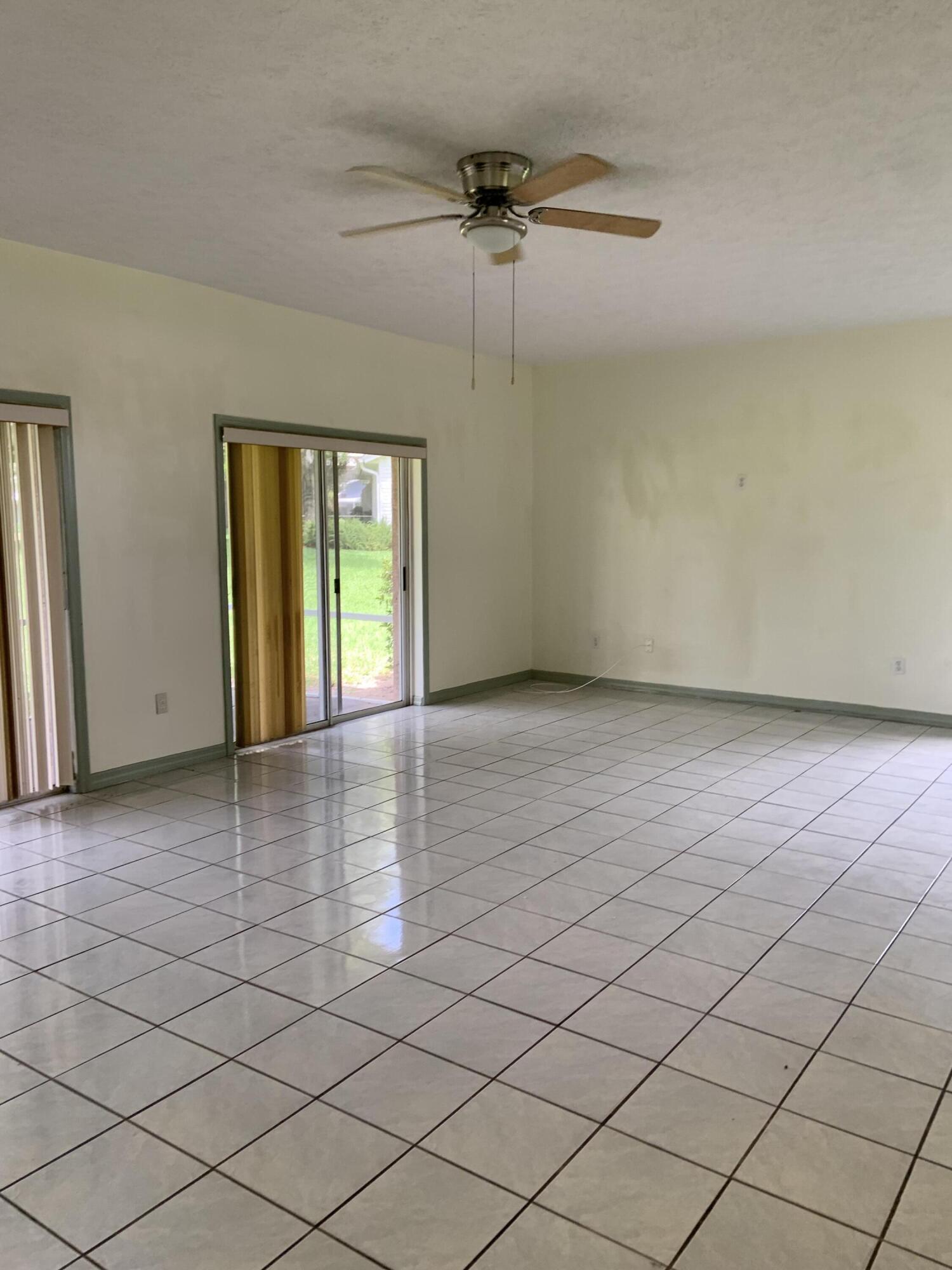 3710 Promenade Way Fort Pierce, FL 34982 - Photo 9 of 26 an empty room with windows and fan