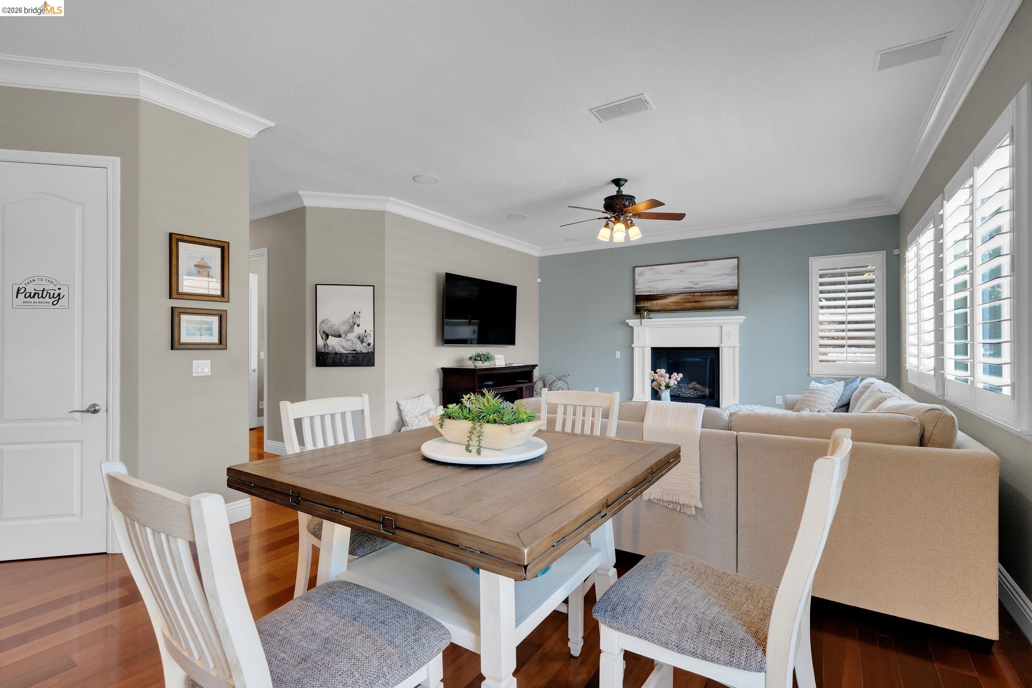 2513 Winged Foot Road Brentwood, CA 94513 - Photo 14 of 45 Open-concept living space featuring rich wood-finish flooring, white crown molding, and plantation shutters