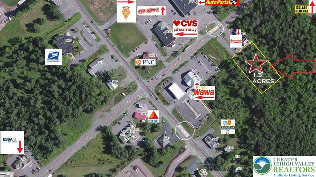 an aerial view of residential houses and car parked