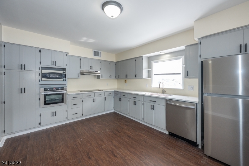 71 Washington Street Morristown, NJ 07960 - Photo 3 of 13 a kitchen with white cabinets and white appliances