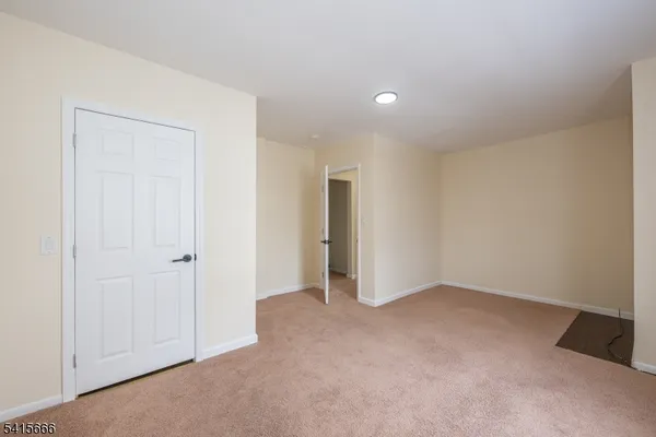 a view of an empty room and closet area
