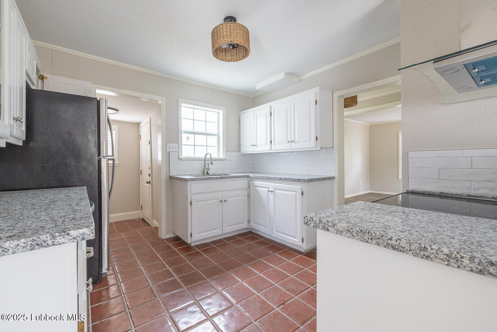 2614 24th Street Lubbock, TX 79410 - Photo 12 of 46 a kitchen with a stove a sink and a refrigerator