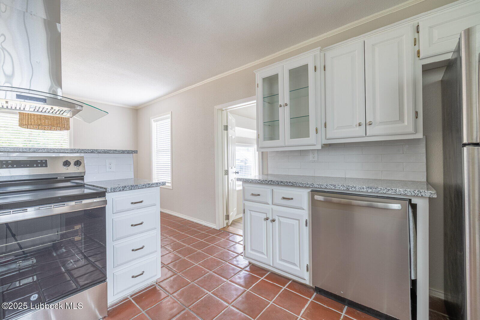 2614 24th Street Lubbock, TX 79410 - Photo 13 of 46 a kitchen with stainless steel appliances granite countertop a stove and a sink