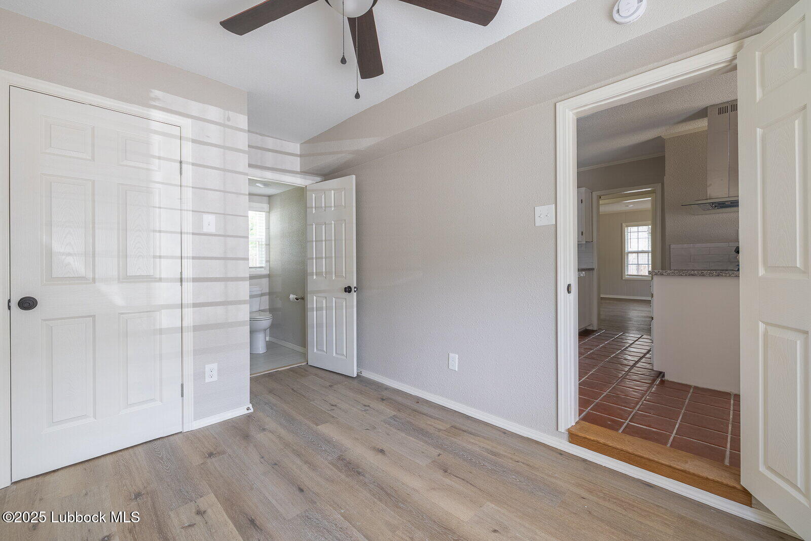2614 24th Street Lubbock, TX 79410 - Photo 17 of 46 wooden floor in an empty room with a bathroom