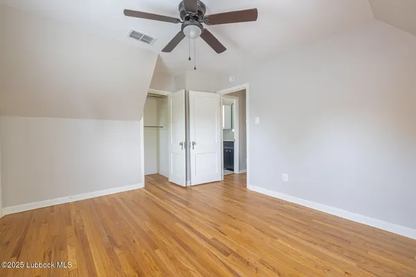 a view of an empty room with a window and fireplace