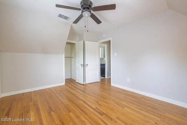 a view of an empty room with a window and fireplace