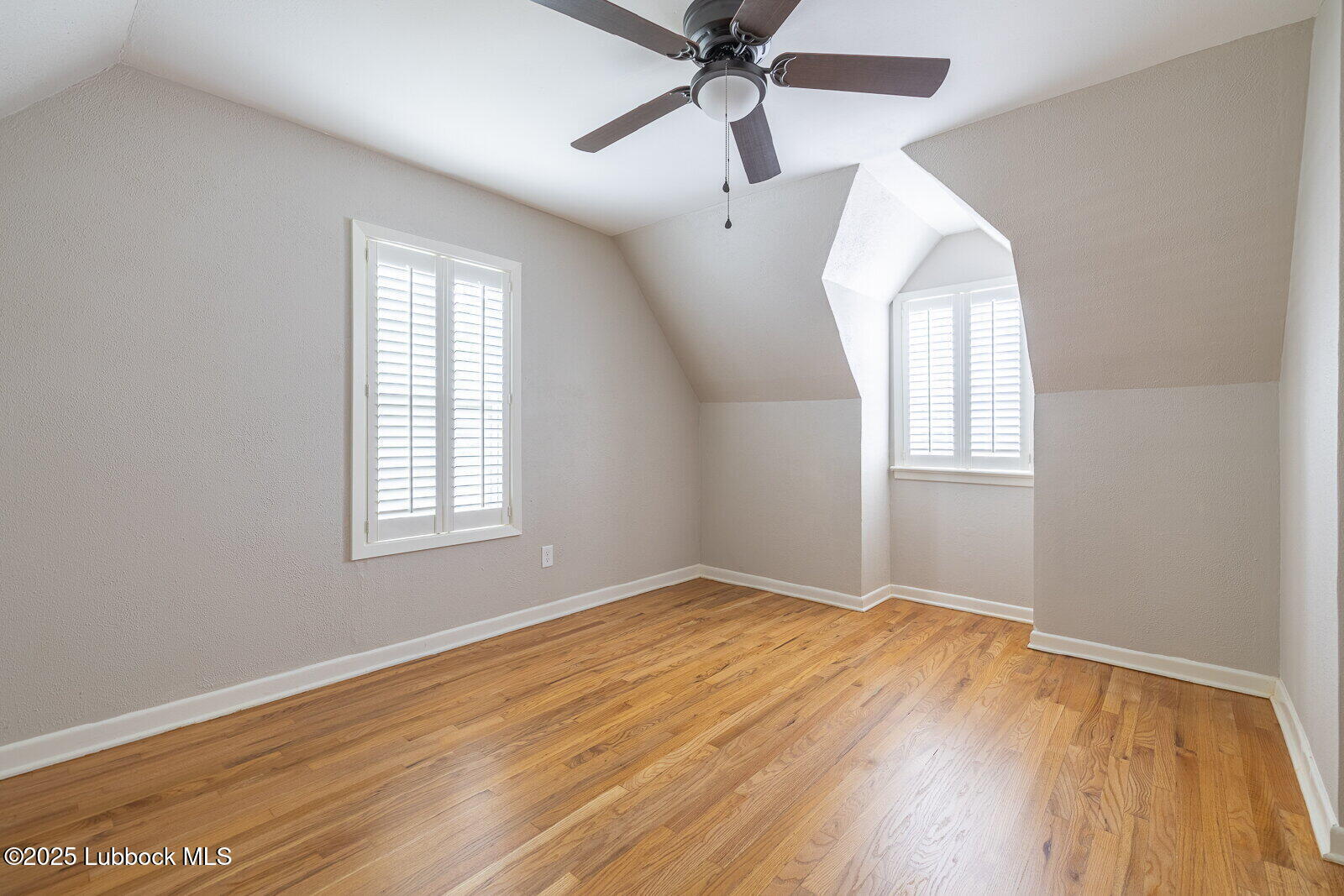 2614 24th Street Lubbock, TX 79410 - Photo 22 of 46 an empty room with wooden floor windows and fan