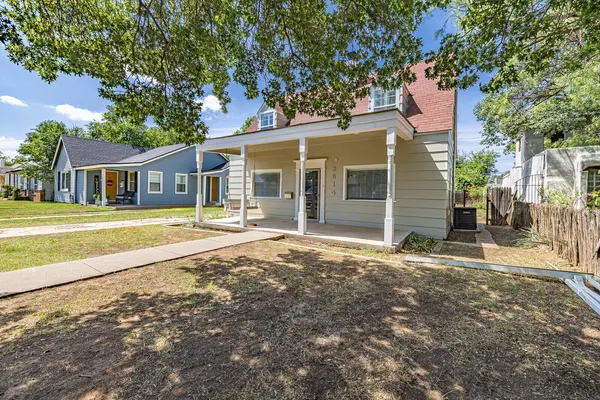 a view of an empty room with a window and fireplace