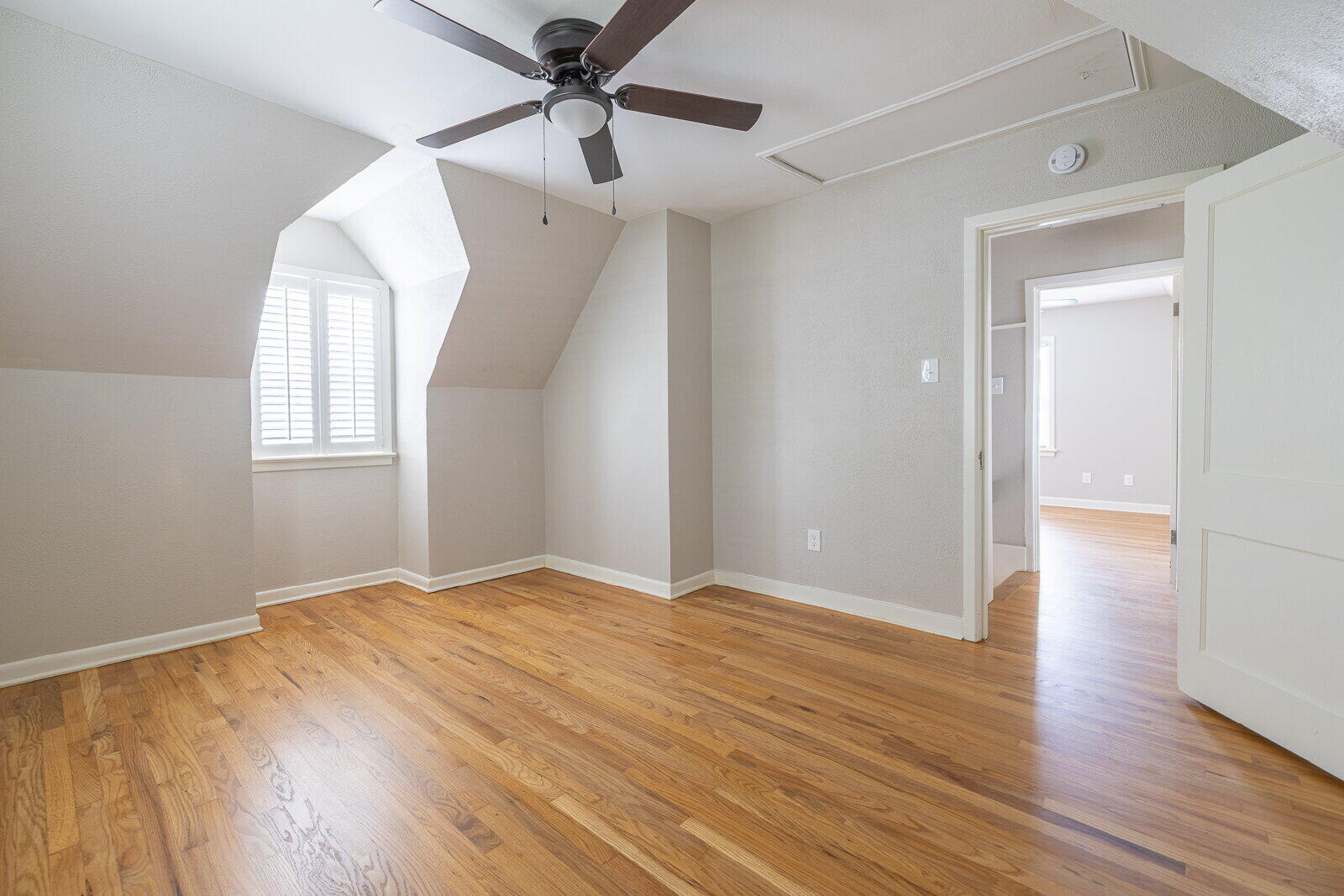 2614 24th Street Lubbock, TX 79410 - Photo 44 of 46 an empty room with wooden floor fan and windows