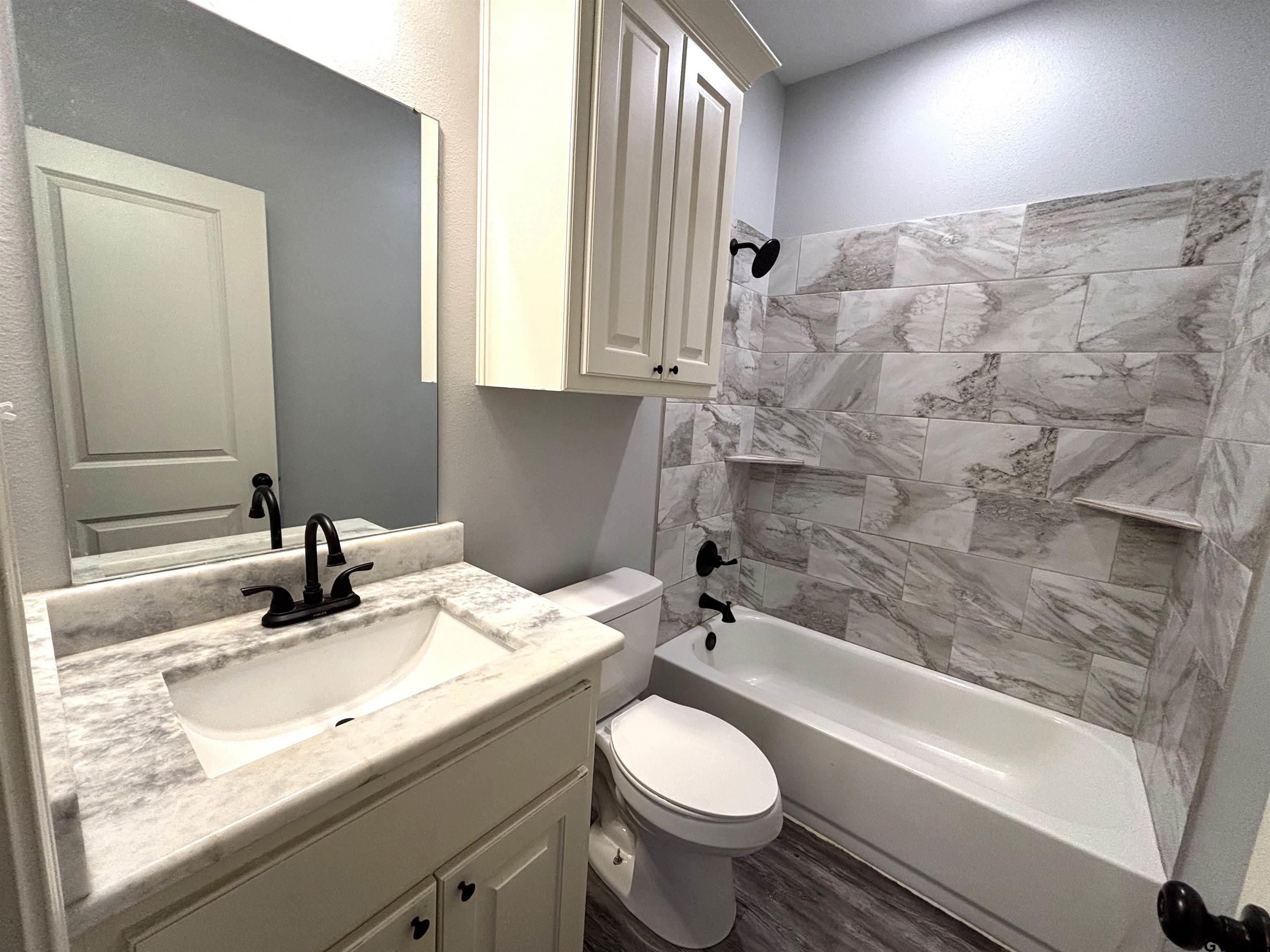 196 Twisted Oaks Road Rusk, TX 75785 - Photo 17 of 25 a bathroom with a granite countertop sink toilet and shower