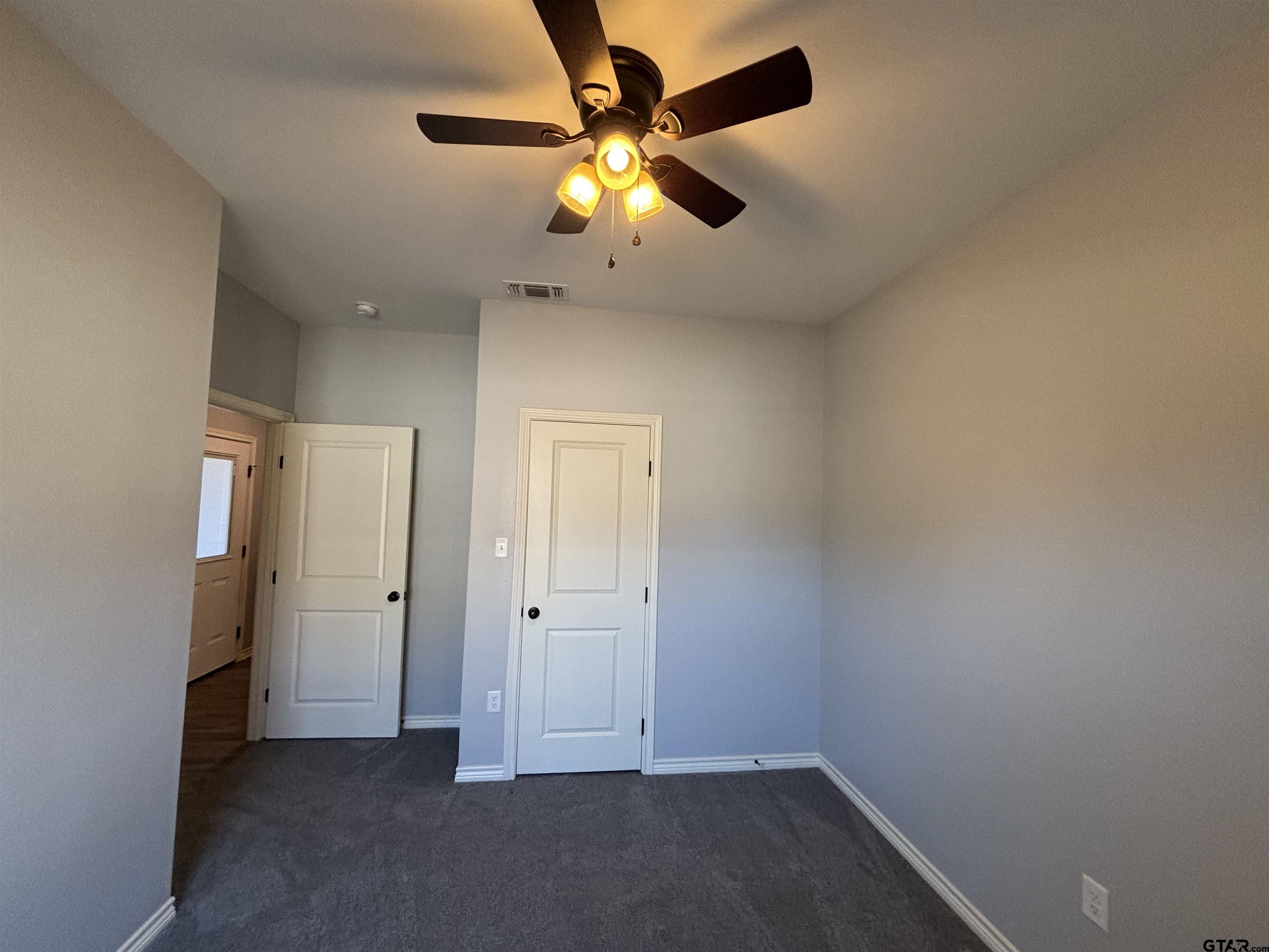 196 Twisted Oaks Road Rusk, TX 75785 - Photo 19 of 25 wooden floor in an empty room with a window