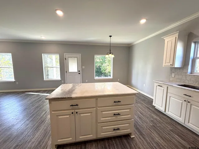 a bathroom with a granite countertop sink window and a mirror