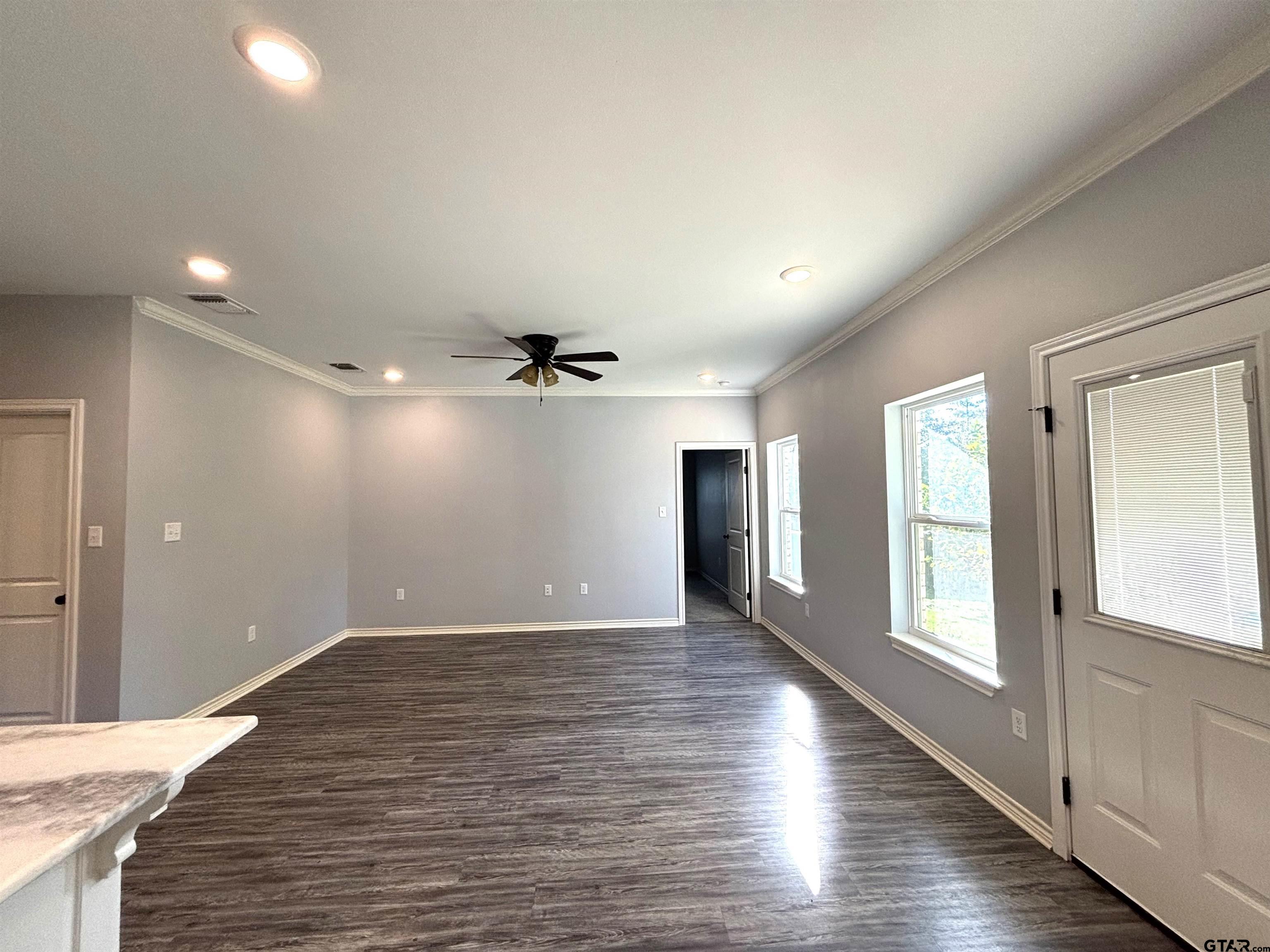 196 Twisted Oaks Road Rusk, TX 75785 - Photo 7 of 25 a view of an empty room with window and wooden floor