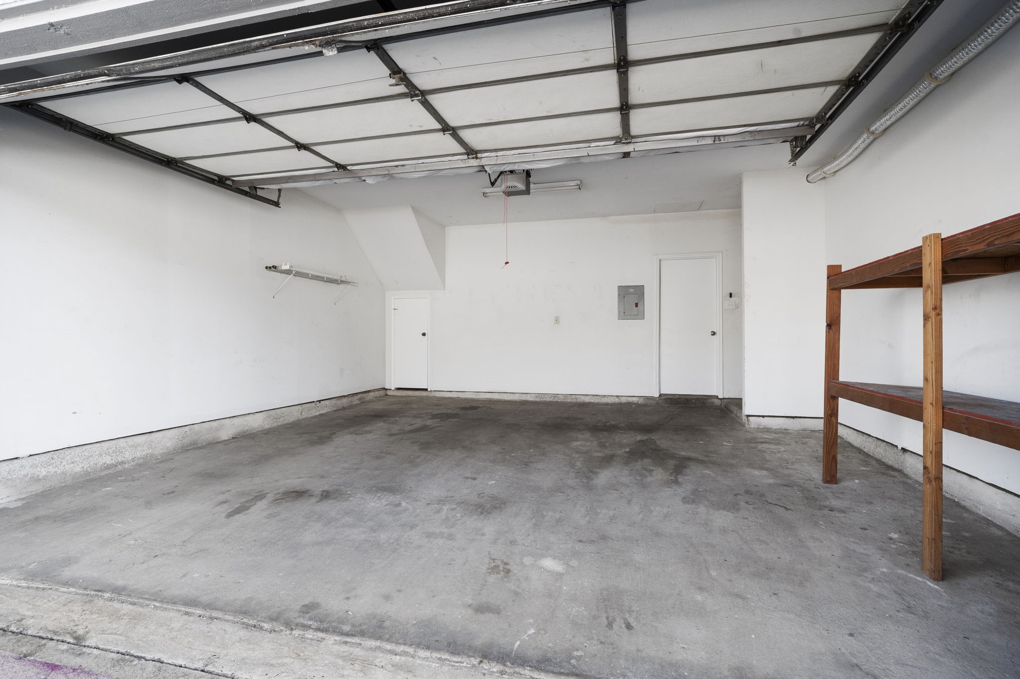 7392 Regency Square Court, Unit 7392 Houston, TX 77036 - Photo 29 of 32 The garage features a convenient storage closet and built-in shelving.
