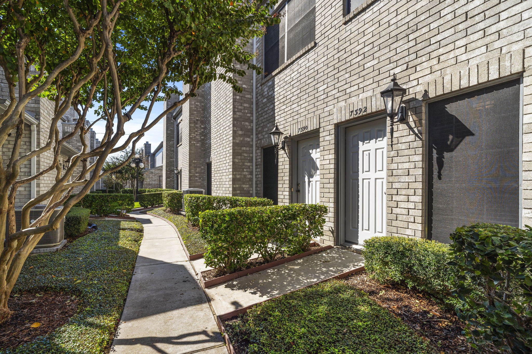 7392 Regency Square Court, Unit 7392 Houston, TX 77036 - Photo 4 of 32 Meandering walkways lead you to the front door overlooking the greenspace, while an attached two-car garage at the back offers convenient direct entry into the home.