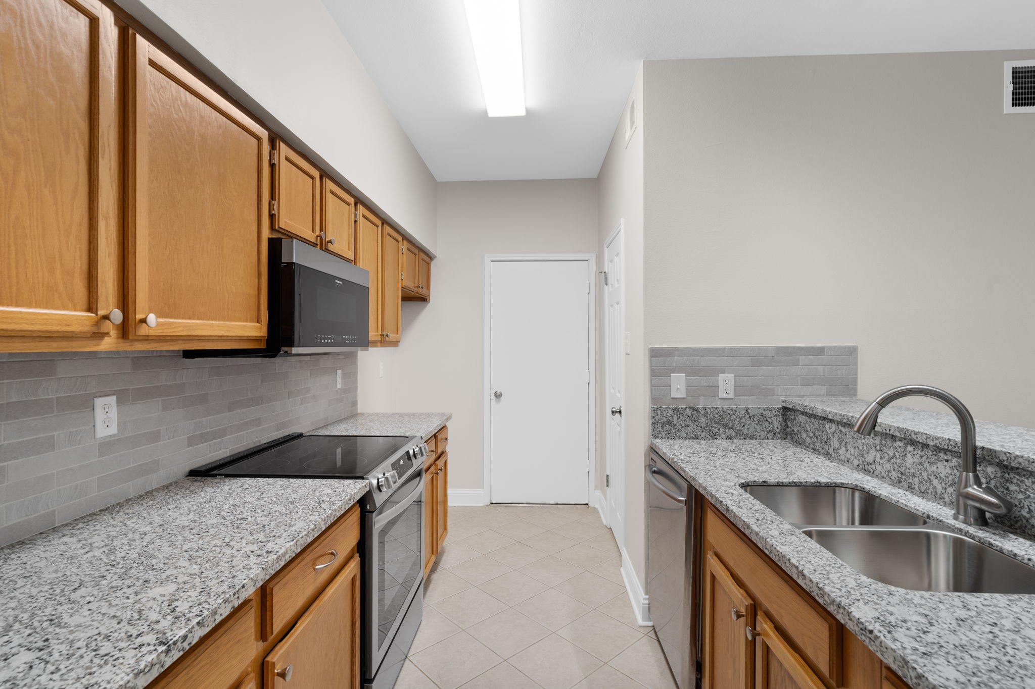 7392 Regency Square Court, Unit 7392 Houston, TX 77036 - Photo 8 of 32 A galley-style kitchen offers an efficient and functional layout that maximizes every inch of space.