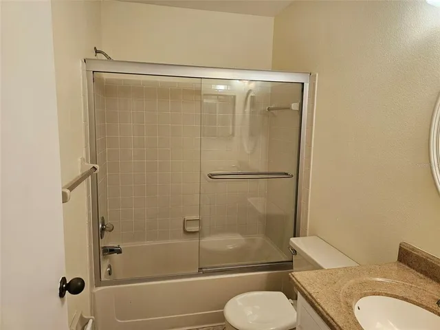 a bathroom with a shower and toilet