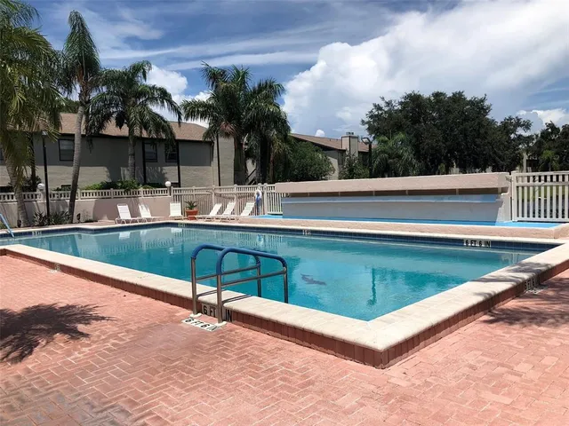 a view of a backyard with swimming pool