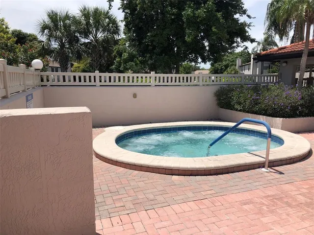 a table with chairs and wooden fence