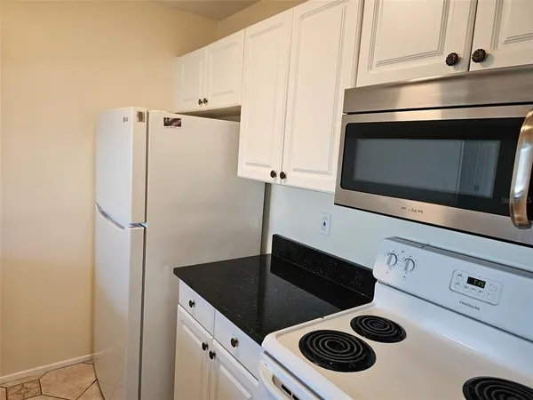 a kitchen with a stove microwave and refrigerator