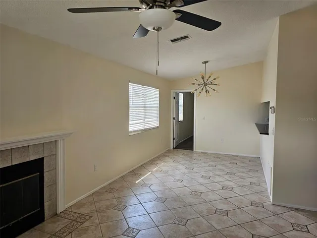 a view of an empty room with a fireplace