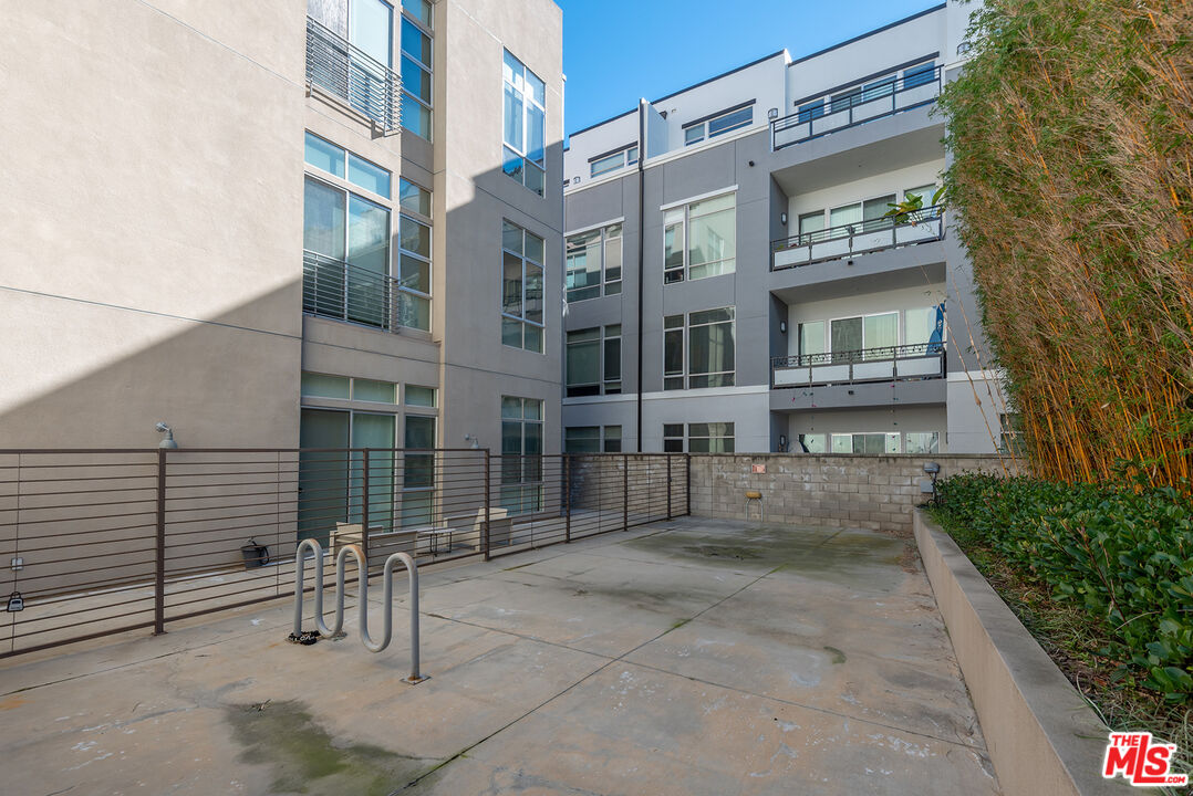 13320 Beach Avenue, Unit 304 Marina del Rey, CA 90292 - Photo 24 of 25 a view of a building with a bench in front of building