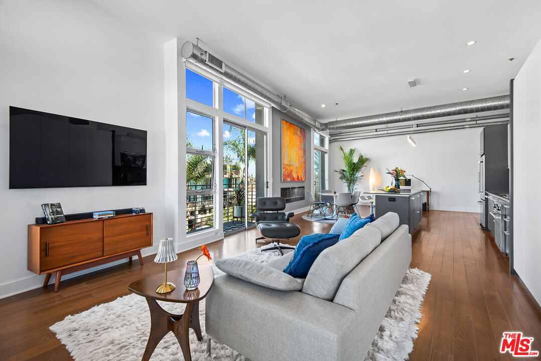 13320 Beach Avenue, Unit 304 Marina del Rey, CA 90292 - Photo 9 of 25 a living room with furniture and a flat screen tv