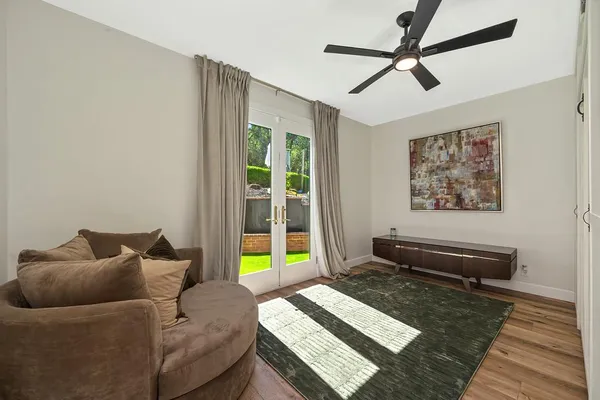 a spacious bedroom with a bed and a flat screen tv