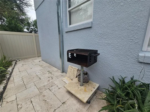 a bedroom with a bed a rug and a potted plant