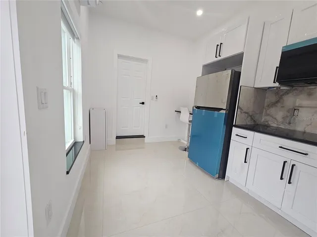 a view of kitchen with refrigerator microwave and wooden floor