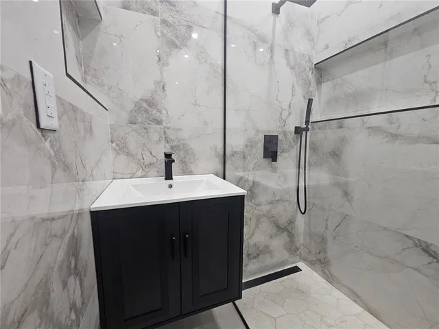 a bathroom with a sink and a shower