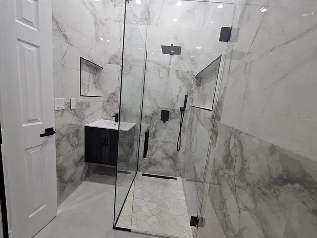 a bathroom with a shower and a sink