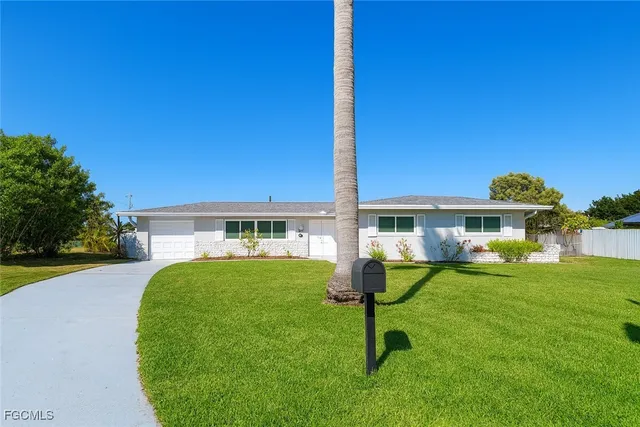 a view of a house with a backyard porch and sitting area