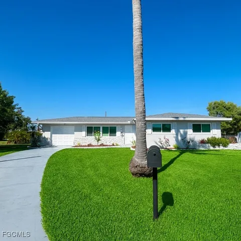 a front view of a house with a yard