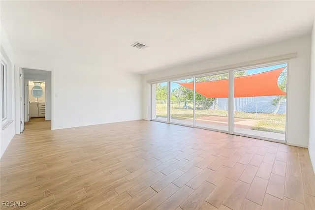 a view of an empty room with a window