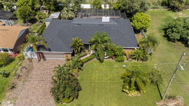 an aerial view of a residential houses with yard